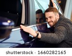 Small photo of . love at first sight, cheerful customer enjoying bought car, happiness, delight, positive feeling and emotion. funny guy striking his own car , close up photo