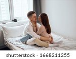 young beautiful woman closing her eyes touching her boyfriend neck, hugging him, happiness, enjoyment. side view full length photo.sexuality.Happy strong marriage