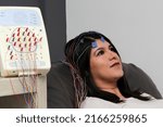 Small photo of Latin adult woman is a patient in the neurology specialty office and an electroencephalogram study is performed to see the electrical activity of the brain