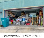 Small photo of Orlando,FL/USA-11/13/19: An unorganized garage filled with a lot of stuff in a neighborhood.