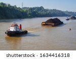 Tug Boat Pulling Coal Barge On...