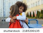 Small photo of girls school friends support each other, hug and help to survive emotions after the school