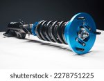 Small photo of auto suspension tuning coilovers shock absorbers and springs blue for a sports drift car on a white background