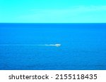 Small photo of Serene scene from Numana Alta with the peaceful waters of the Adriatic Sea only slightly perturbed by rippling waves and a white mini-yacht whizzing on its surface and leaving a milky white trail