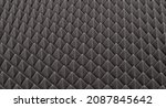 Small photo of Dark gray triangular acoustic and studio sound proof foam pattern texture. Shock proof foam. The pattern of the sound proof panel of polyurethane foam. Selective focus.