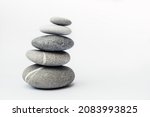Small photo of Stone cairn on light background, stones tower, simple poise stones. Purity harmony and Balance Concept. Place for text.