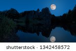 Small photo of With Moonlight an uncanny place deep in the forest are the sandstone cliffs in East Westphalia in Germany, The Externsteine.