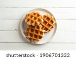 Delicious belgian waffles white wooden rustic background, top view.