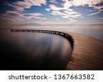 Small photo of Close up front view of wooden curved long deck pier or dockage in circular angle on the sea in Sekapark, Izmit, Kocaeli, Turkey. Artifical natural park near seacoast.