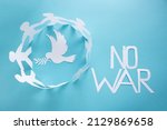 There is no war. People cut out of paper on a blue background protect the dove of peace.The concept of the World Peace Day