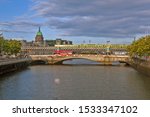Small photo of DUBLIN, IRELAND - AUGUST 19, 2019: Photo of View of the Liffey River and the Stykova Bridge, with the loopback bridge behind it.