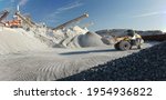 Panorama of a mining plant, with a front-end loader transporting crushed stone.