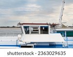 Small photo of the wheelhouse of a large river ship standing on the roadstead in the port