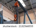 Small photo of The construction crane in factory. chain hoist hanging on steel box