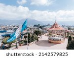 Small photo of Central park in San Marcos Guatemala - Guatemalan flag waving in the central square with old kiosk - picturesque Latin American park