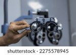 Small photo of Close up optician hand adjusting Phoropter ophthalmology,optometry, testing device machine equipment in optical clinic,eye doctor adjust ophthalmic bio microscope for eye exam in optic clinic