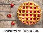 Traditional strawberry pie tart cake sweet baked pastry food on rustic wooden table background