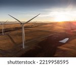 Small photo of Aerial sunset view of working windmills producing sustainable energy near Pincher Creek Alberta Canada.