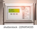 Fire alarm system with active alert.  Evacuation alarm display. Control panel with alarm active message and flashing red lights. Fire panel in service room of residential and commercial building. 