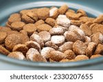 Small photo of Medication in kibbles or pet food. White powder sprinkled in food dish for cat or dog. Administer medication, drug treatments, supplements, probiotics or vitamins to animal patients. Selective focus.