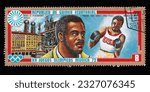 Small photo of Ankara,Turkiye - 07.05.2023: A stamp printed in Equatorial Guinea from the "Olympic games, Munich" issue shows Joe Frazier (1944-2011) and Marienplatz, circa 1972.