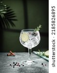Small photo of Gin tonic cocktail and shadows next to the window on dark concrete background. Vertical format.