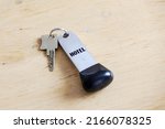 hotel key on wooden table.... | Shutterstock . vector #2166078325