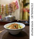 Small photo of A bowl of Indonesian instant noodles with eggs, crispy fried shallot, and green vegetables served in a local stall, familiar by name Warmindo or Warung Burjo.