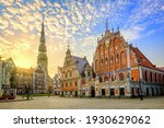 City Hall Square with House of the Blackheads and Saint Peter church in Old Town of Riga on dramatic sunrise, Latvia