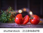 Two Tomatoes Lie On A Cutting...