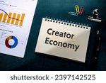 There is notebook with the word Creator Economy. It is as an eye-catching image.