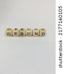 Small photo of Gerund - wooden cubes with letters