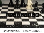 Small photo of The concept of Spellbind represented by black letter tiles with chessboard background