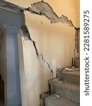 Small photo of Deplorable image of the broken and spilled walls while climbing the stairs of a duplex house damaged in an earthquake
