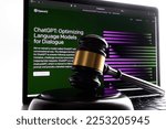 Small photo of Gavel in front and blurred ChatGPT front page seen on laptop. Concept for lawsuit and copyright. Artificial intelligence AI chatbot by Open Ai. Stafford, United Kingdom, January 23, 2023