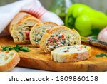 Baguette stuffed with a salad of baked chicken, cheese and fresh vegetables-bell pepper, tomato, garlic, parsley. Delicious homemade appetizer for gourmets. Selective focus
