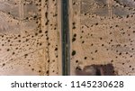 Small photo of Bird’s eye view of famous highway in America located on west wild sandy lands, aerial view of historic Landmark Route 66 with old cracked asphalt in desert environment
