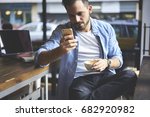 stock-photo-concentrated-casually-dressed-male-freelancer-checking-email-box-waiting-for-transaction-using-682920982.jpg