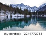 Scenic view of lago di fusine inferiore near Tarvisio in Friuli-Venezia Giulia region of Italy and Mangart mountain in Julian alps in winter