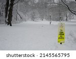 Small photo of MANHATTAN, NEW YORK, USA - Feb 03, 2014: An incongruous sign forbids bicycle riding on paths in Central Park, at Central Park West and W 103rd St, during a snowstorm.