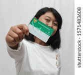 Small photo of Yogyakarta, Indonesia - November 26, 2019 : Holding Kartu Indonesia Sehat (Health Insurance card from the Government of Indonesia) under the auspices of the BPJS.