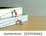 Small photo of Miniature people toy figure photography. Bookshelf library concept. A group of student pupil returning and borrow a book