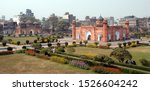 Lalbagh Fort in Dhaka, Bangladesh. This is the tomb of Bibi Pari in the grounds of Lalbagh Fort, Dhaka. To the left with three domes is Lalbagh Fort Mosque. Tourist sight in Dhaka, Bangladesh.