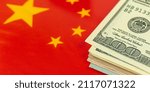 Small photo of Dollar bills over the China flag. Criminal and corruption concept. Outlaw, ghetto, social problem and background