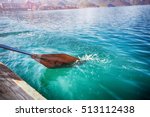 Oar Of Boat Touching Water And...