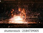 Small photo of Dramatic sparky scene of a man using an oxyacetylene torch