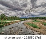 Small photo of The beauty of kabacan river in Magpet, North Cotabato Philippines. with a dark sky and green tropical vegetation.