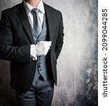 Small photo of Portrait of Butler or Hotel Concierge in Dark Suit and White Gloves Eager to Be of Service. Professional Courtesy and Hospitality.