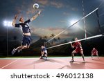 Professional volleyball players in action on the night court