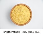 Small photo of millet grains in a wooden bowl on a white background, subject photography